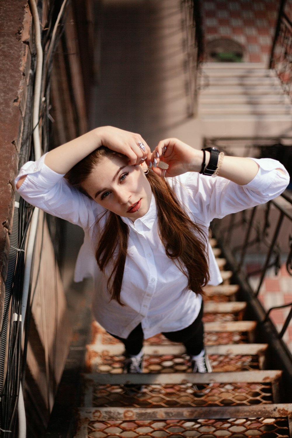 woman standing on metal stairs