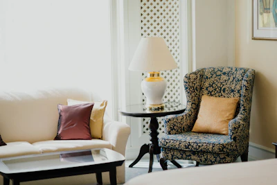 Elegant designer sofa set in a spacious living room with soft lighting and gold accents.