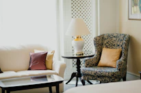 A cozy living room with elegant white and gold furniture pieces, showcasing comfort and style.