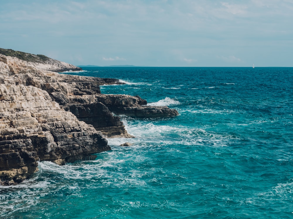 cliff and sea during daytime\