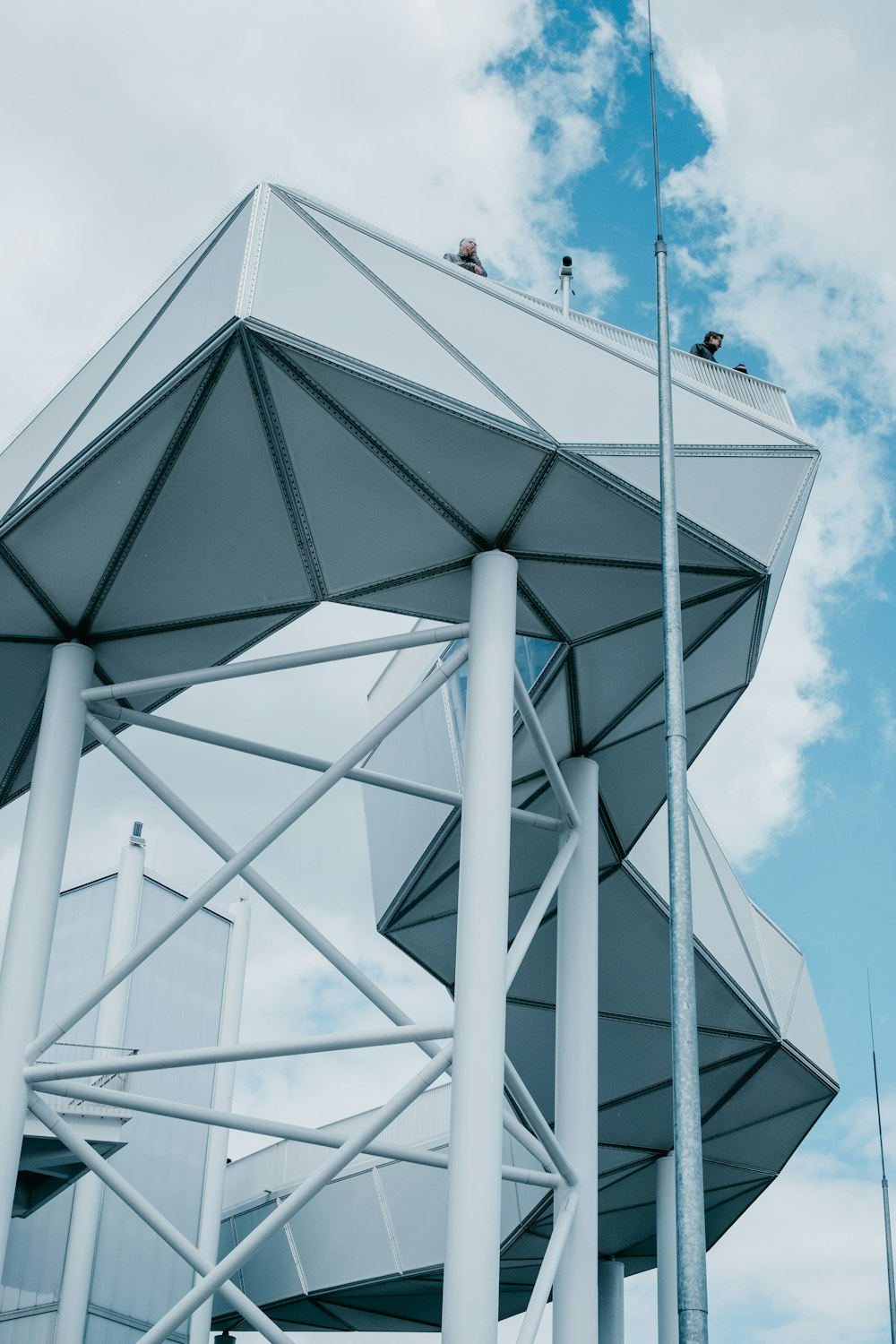 white concrete building under white clouds at daytime