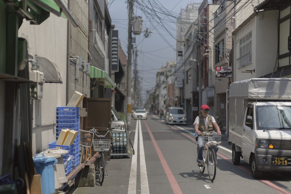 truck and bicycle travelling side by side on street