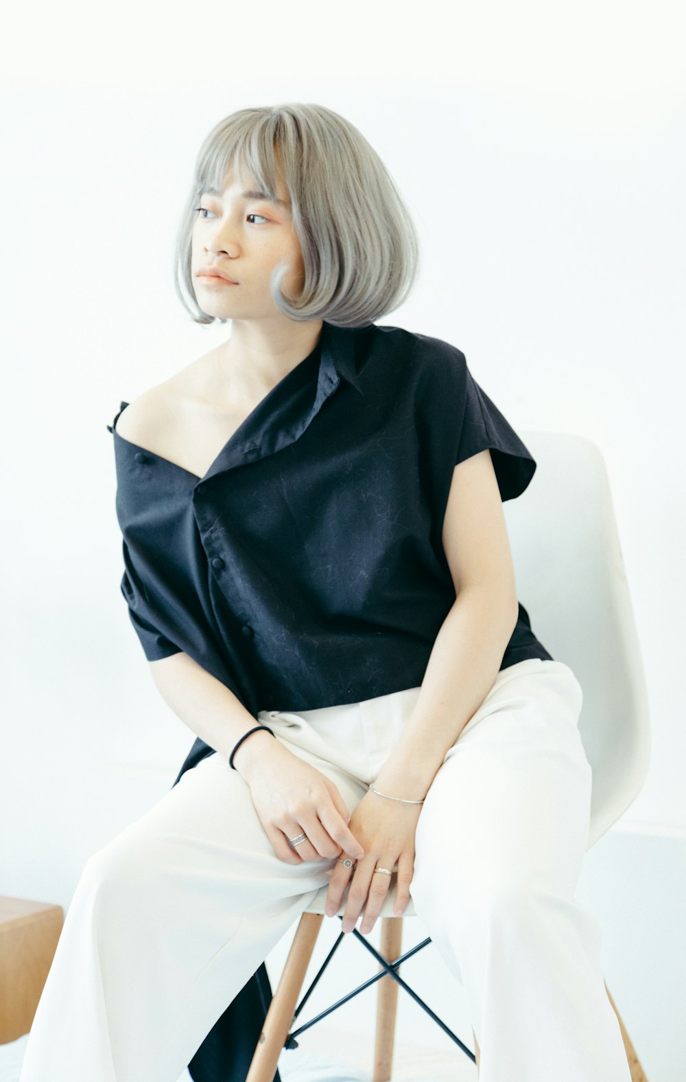 woman wearing black shirt sitting on stool