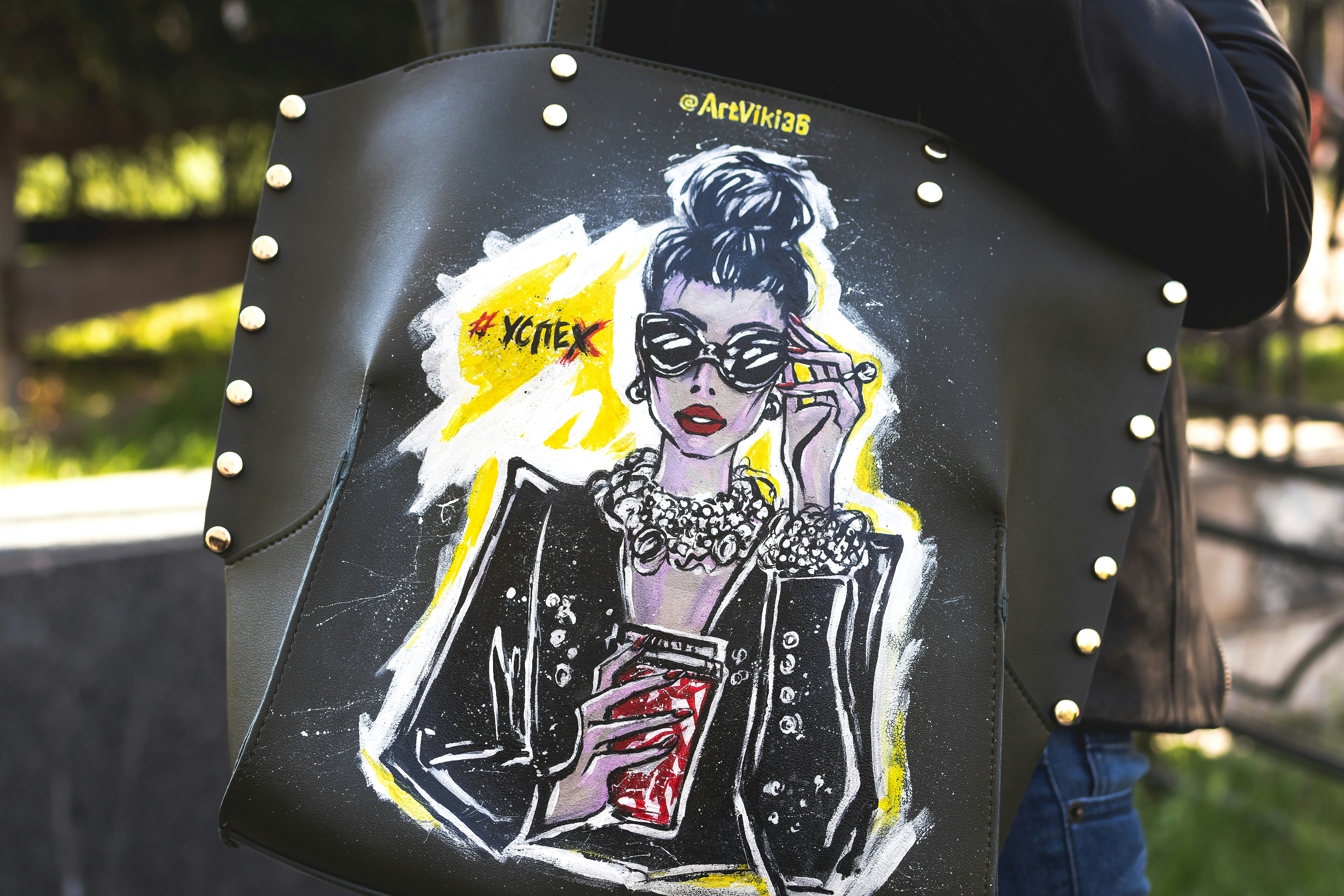 woman carries hand painted bag