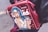 A leather bag with a pop art illustration of a surprised woman with blue hair and red glasses holding a takeaway coffee cup. The bag is red with white dots and has text written in Cyrillic script. The person carrying it is wearing a black leather jacket.