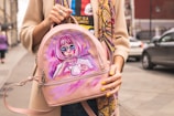 woman carrying pink painted brown leather backpack