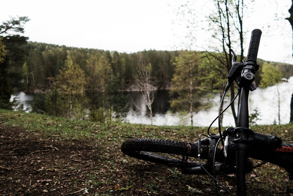 mountain bike lying on ground near lake