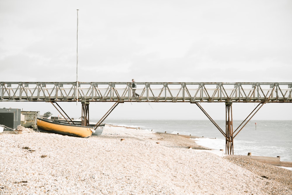 boat on shore under bridge dock