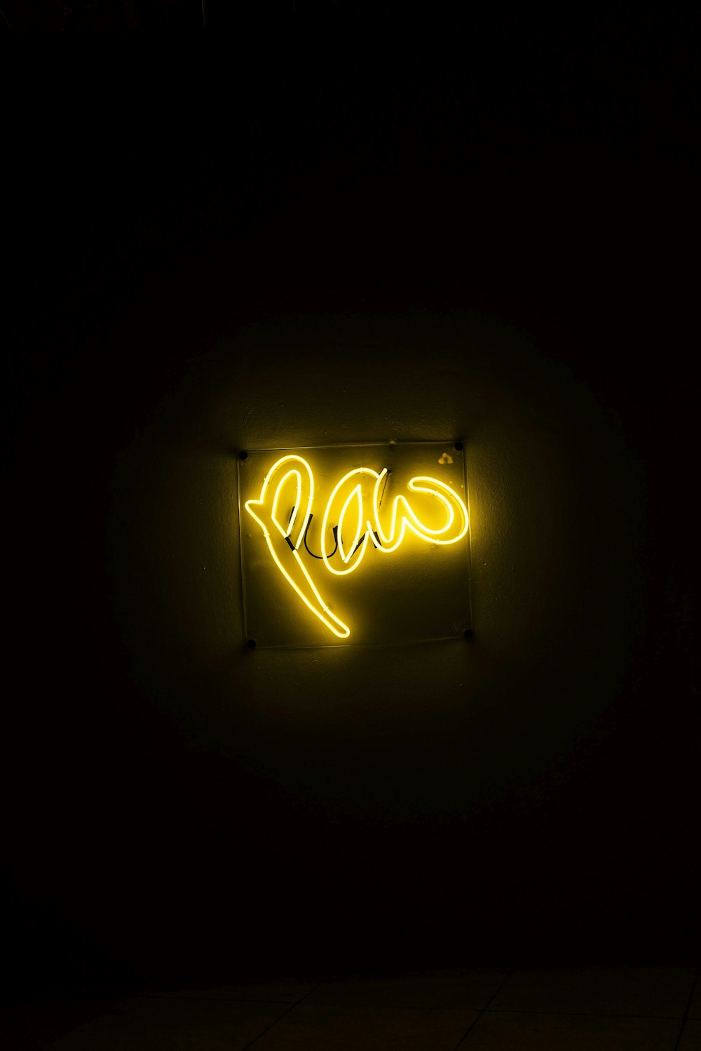 a neon sign that says love in a dark room