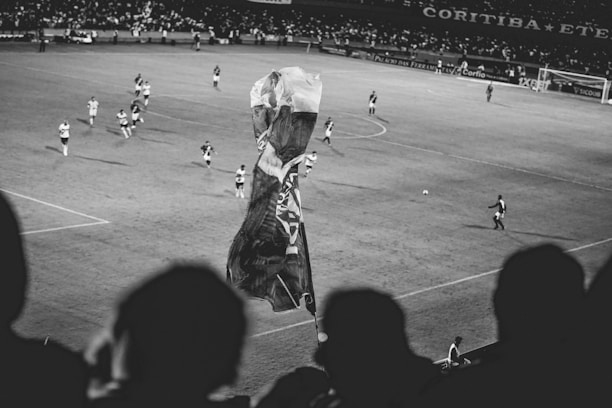 Close-up of a printed photo of a fan captured during a soccer match.