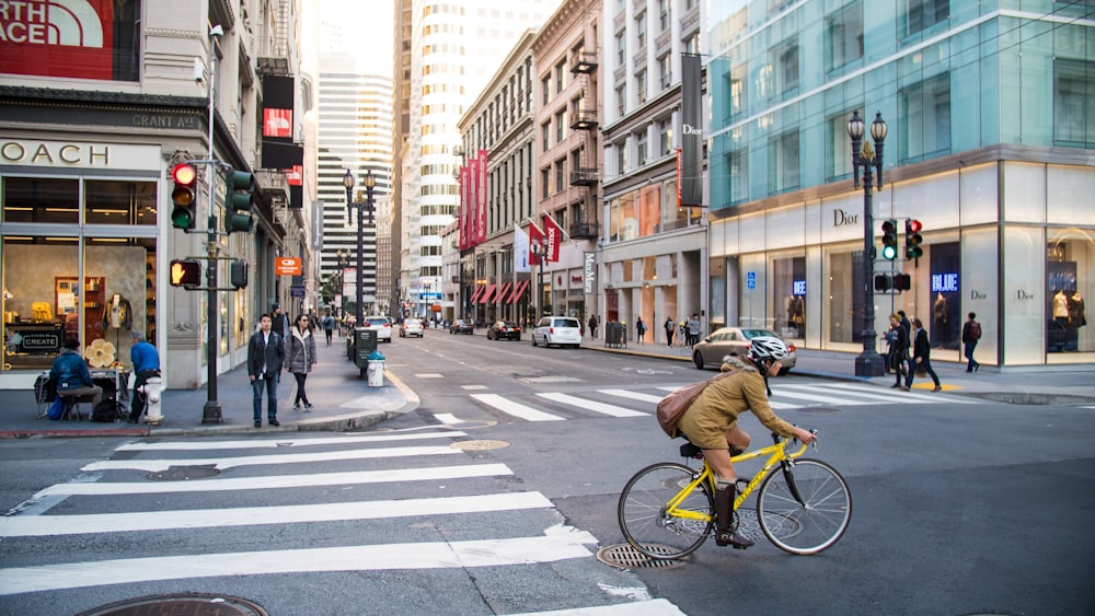 woman biking on a road intersection