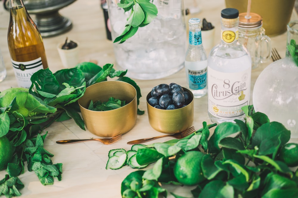 blueberries and spinach on brass-colored bowls