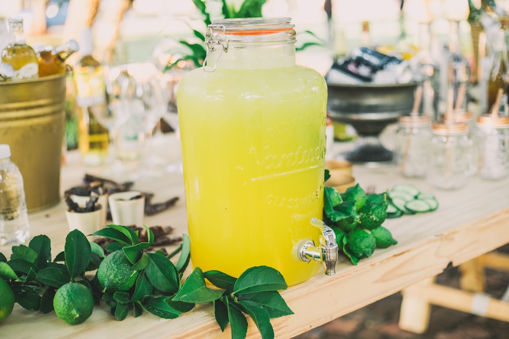 clear glass water jug filled with yellow liquid