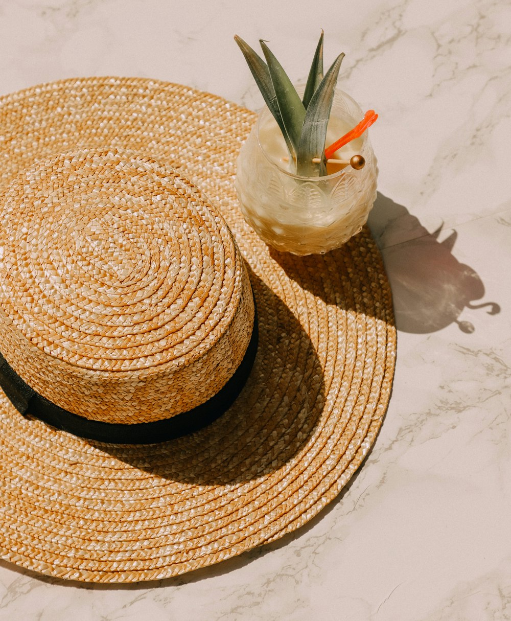 pineapple glass drink on brown sunhat
