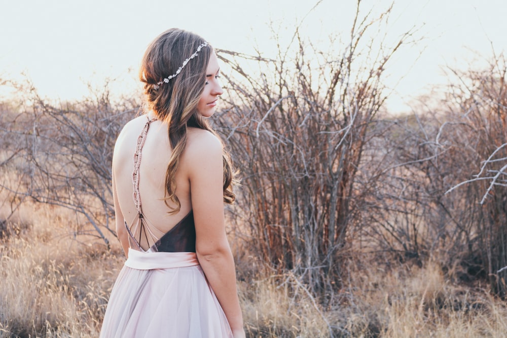 woman standing near grasses