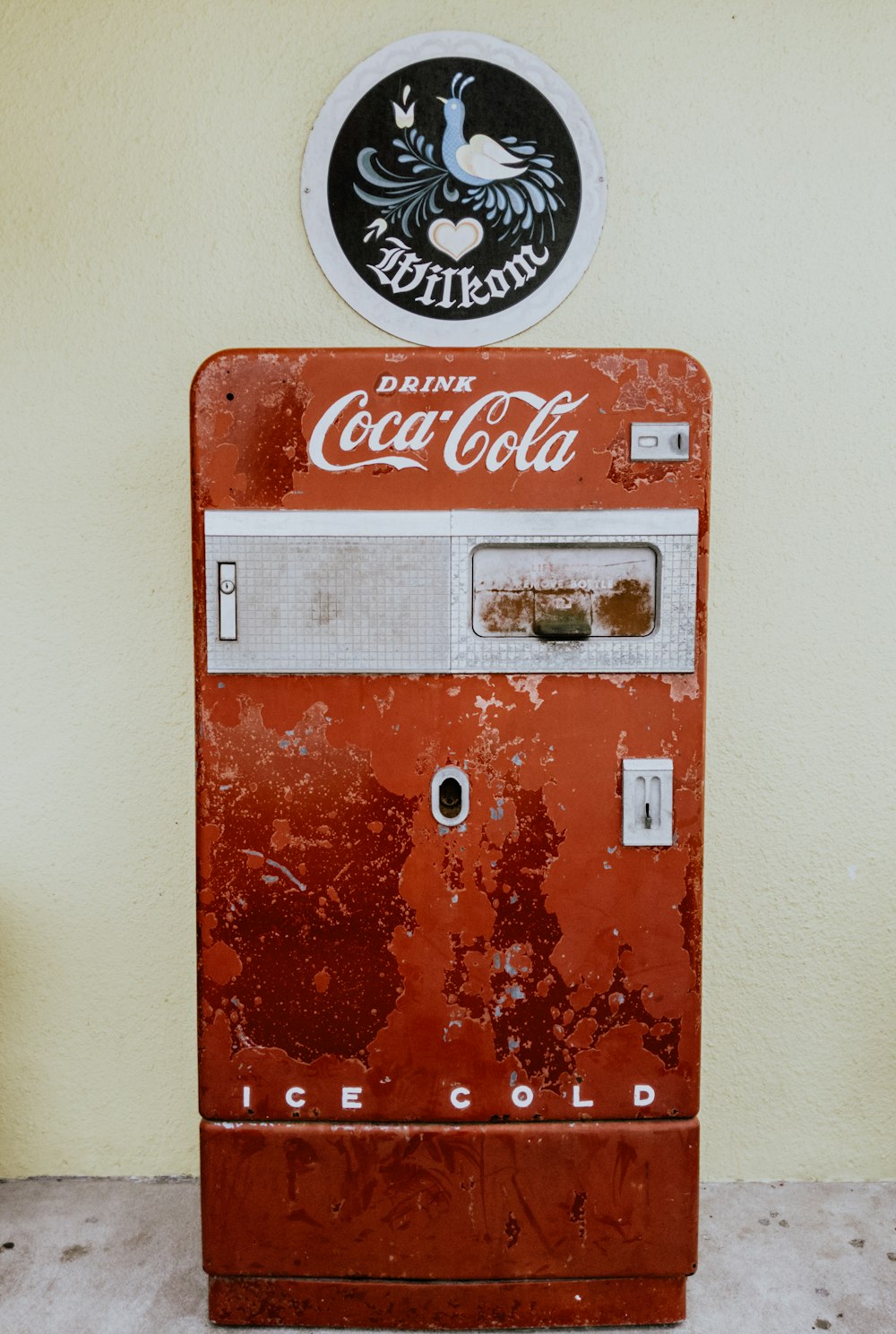 Coca-Cola refrigerator beside wall