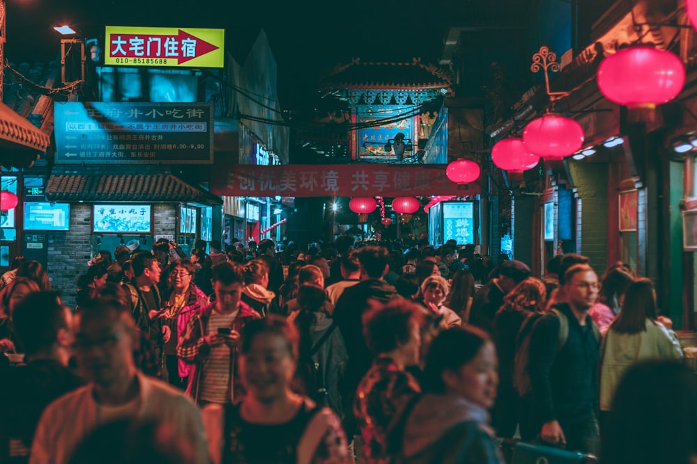 several people walking beside stores