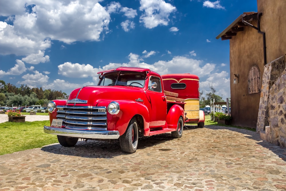 red vehicle near house