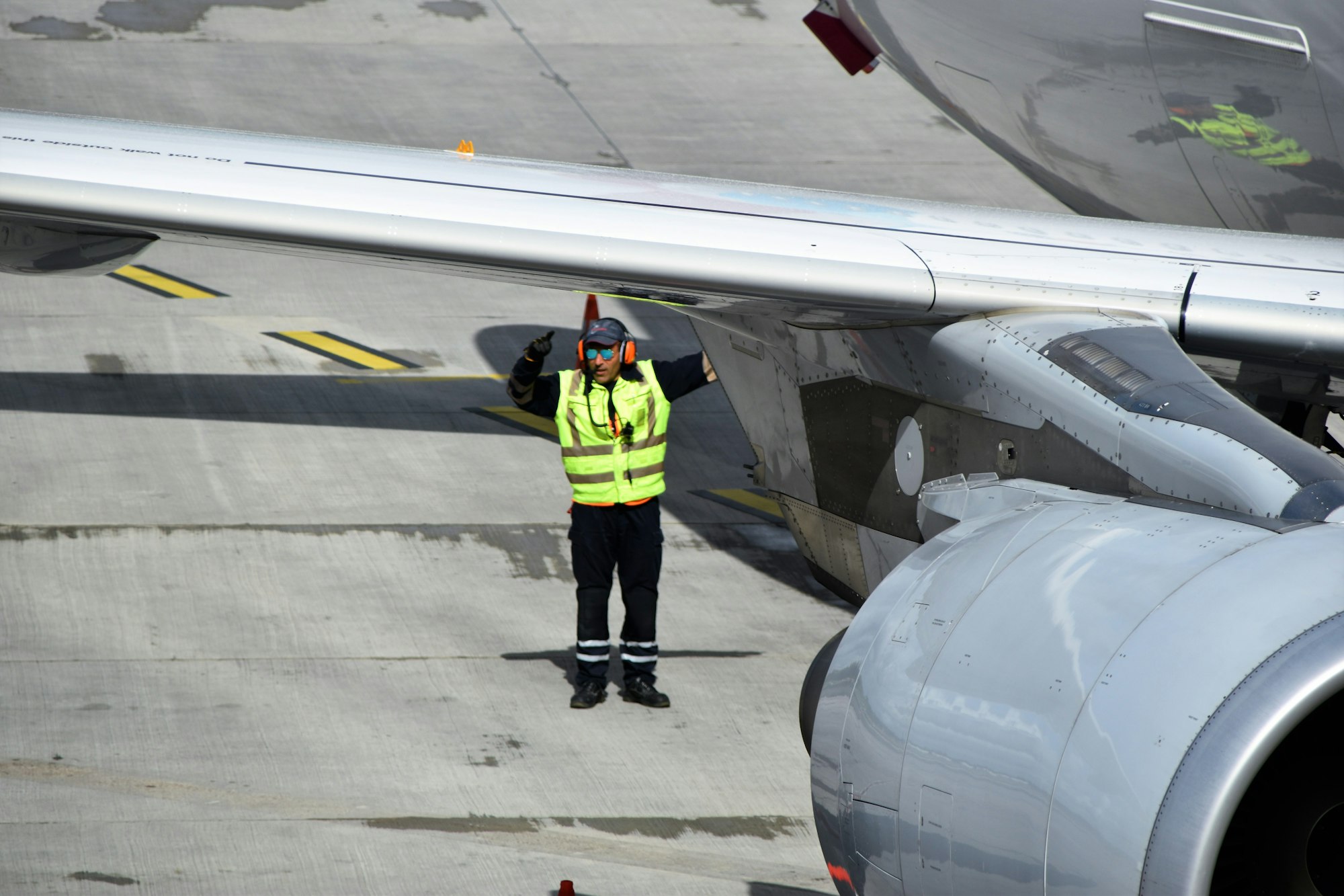 A ground crew member in a high-visibility suit