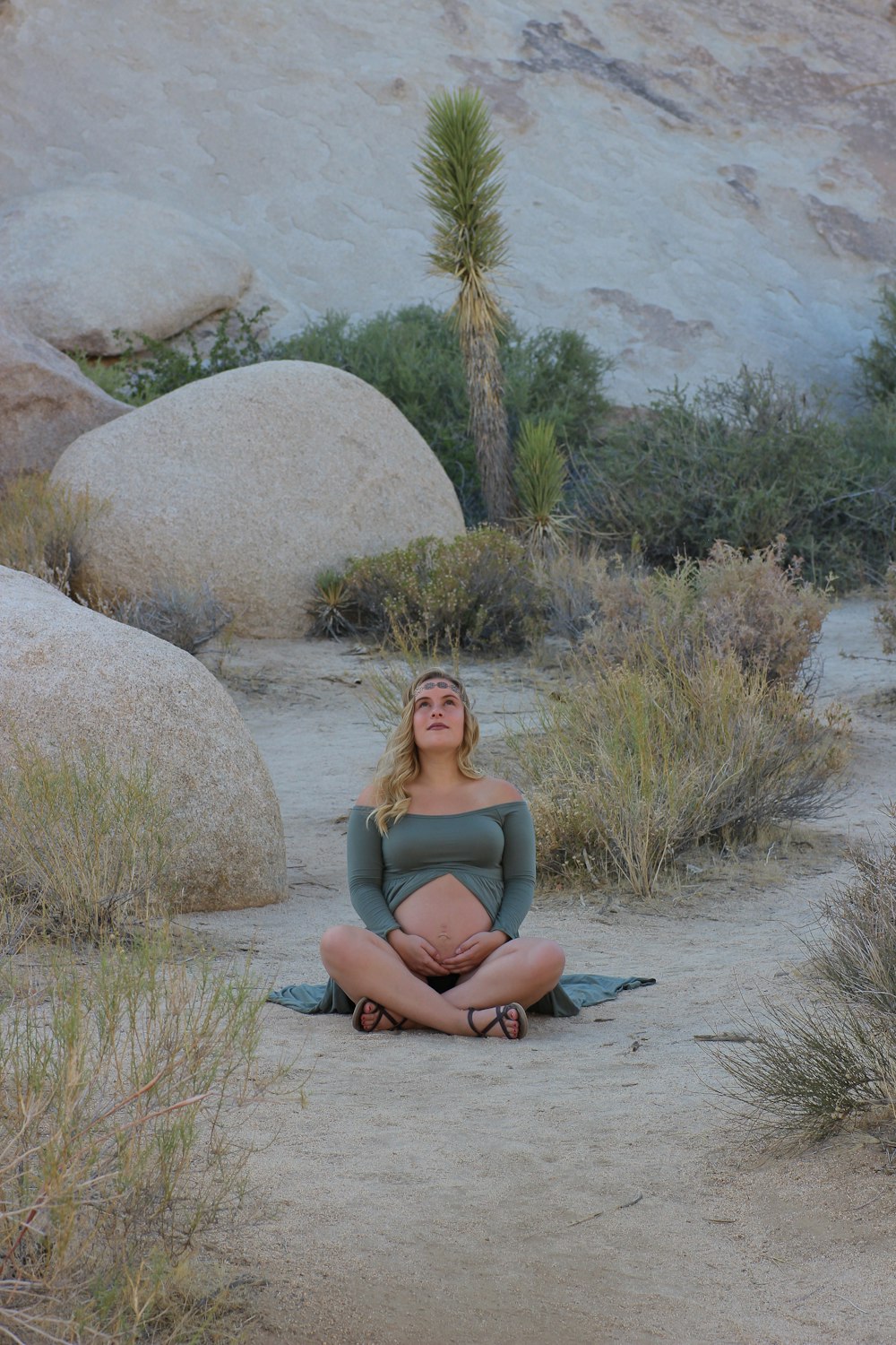 woman seated near rock