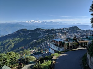 A scenic view of Dehradun with a taxi in the foreground.