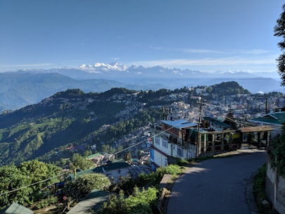 A scenic view of Dehradun with a taxi in the foreground.