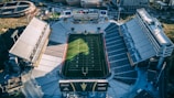 Aerial view of the stadium before renovation, showing old stands and empty field