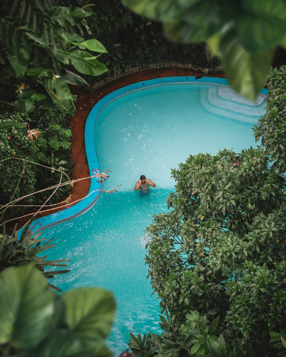 man in swimming pool during daytime