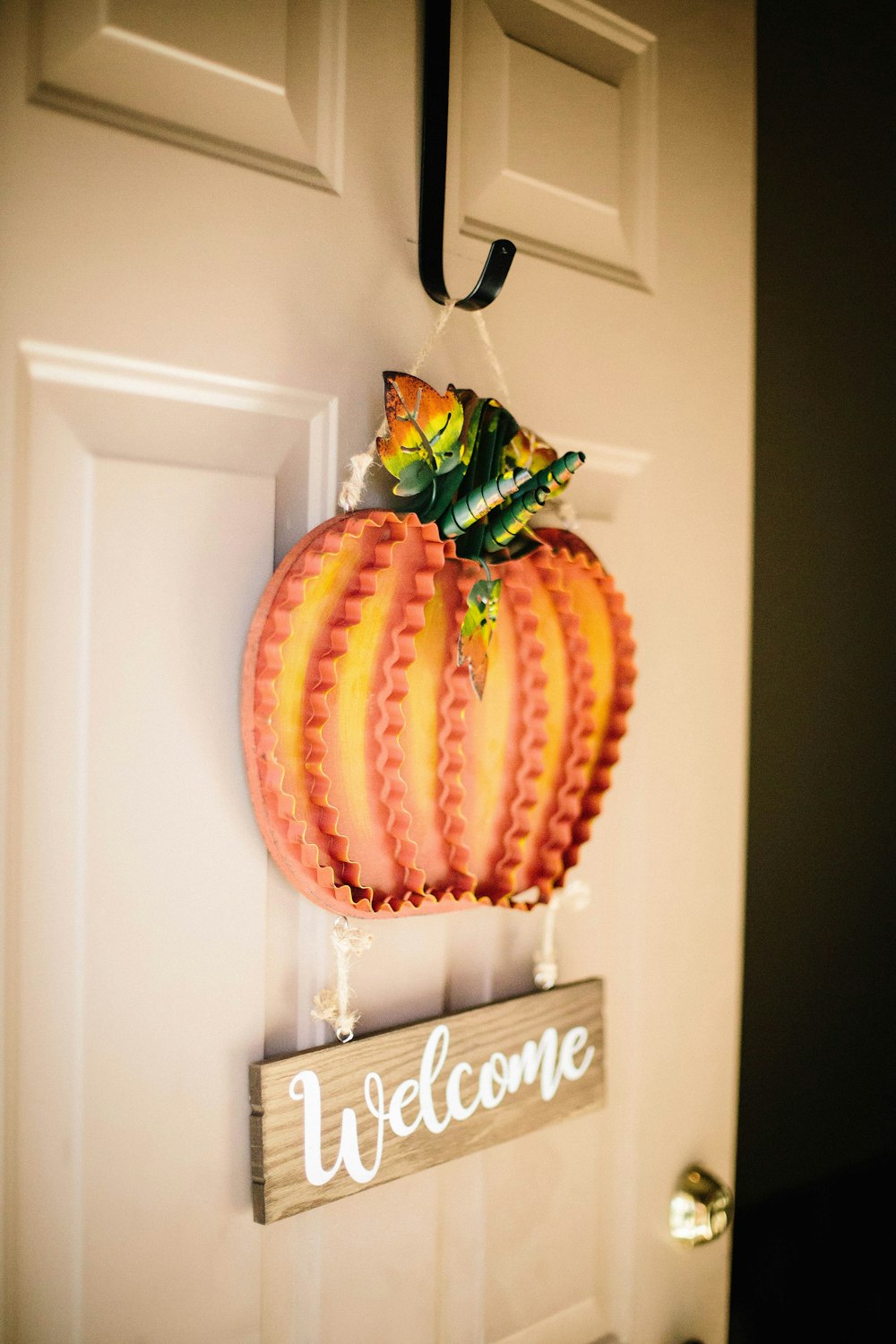 orange and brown wooden welcome door hanging decor