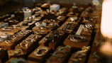 Stylish arrangement of bracelets and rings on a wooden table with natural light.