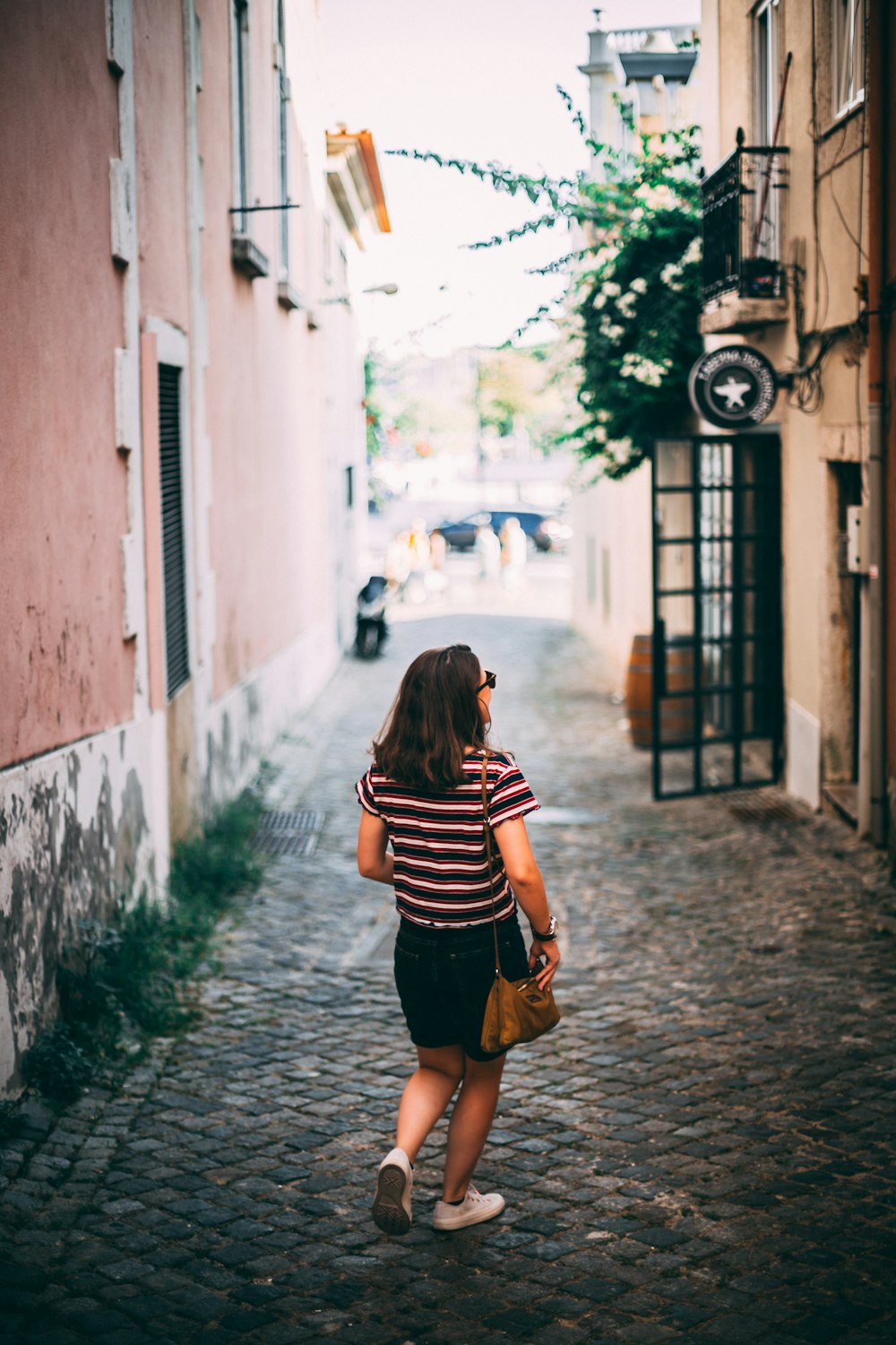 woman walking on hallway looking up