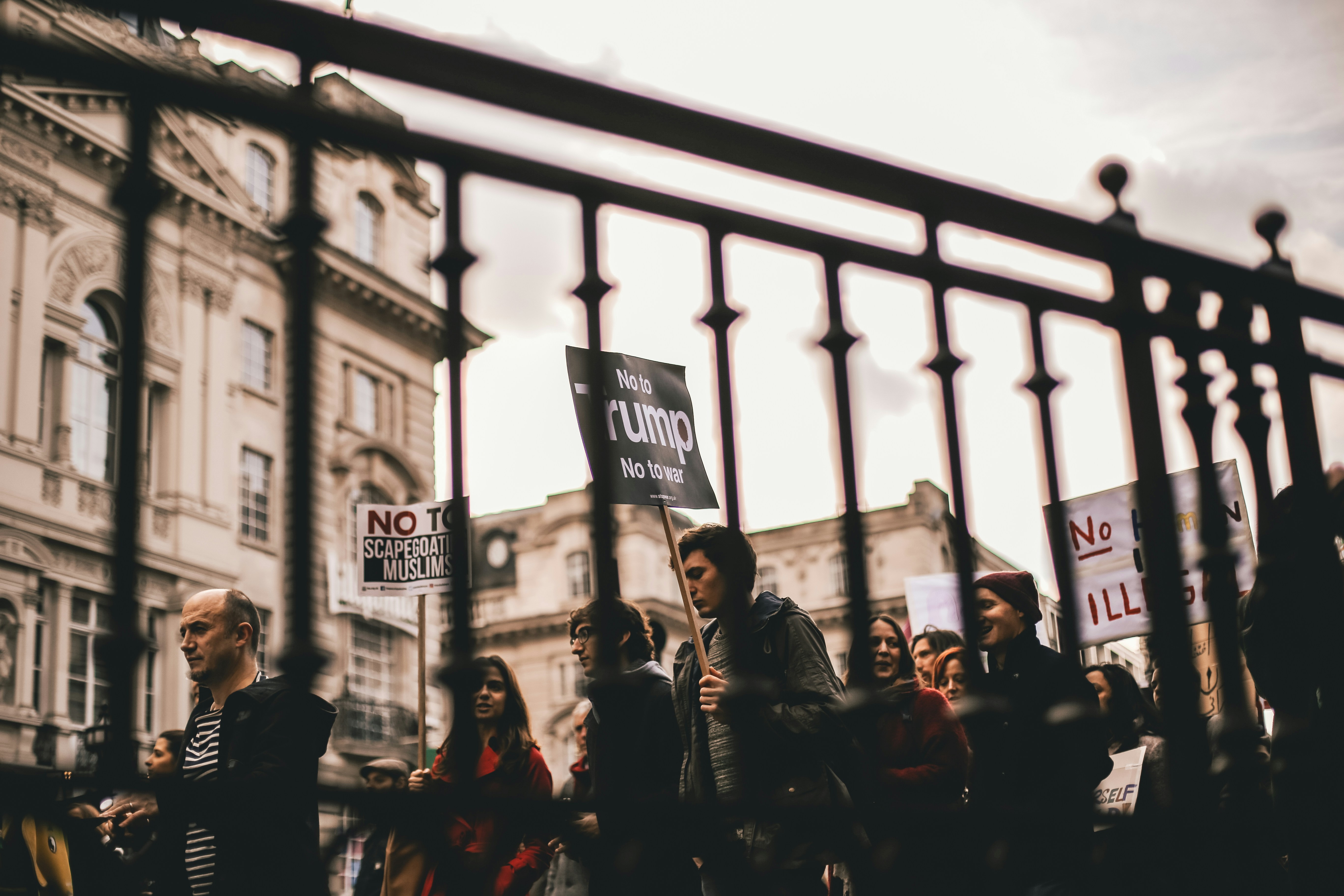 people walking with signs at the city during day