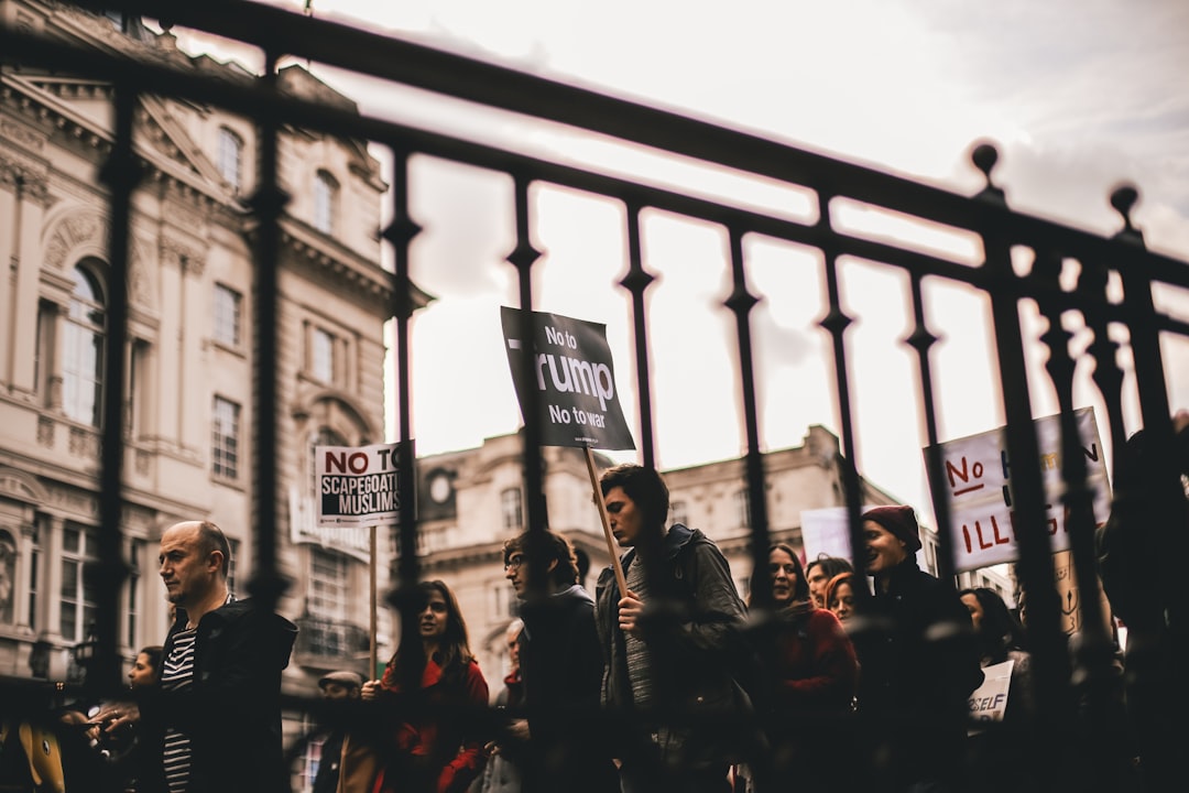 people walking with signs at the city during day