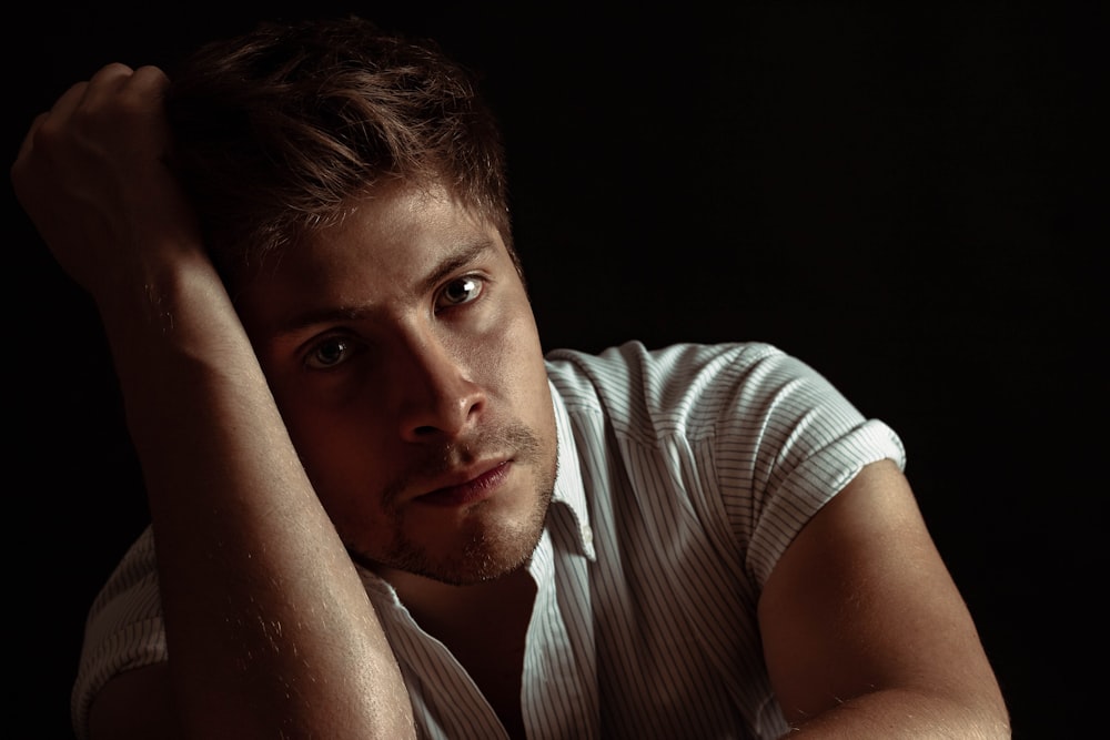 man wearing white and gray striped shirt