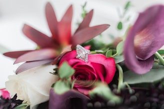 A sparkling diamond heart resting on a bed of fresh white roses