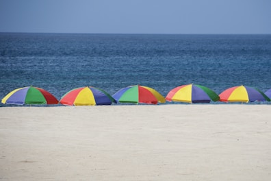 five parasols at the shore during day