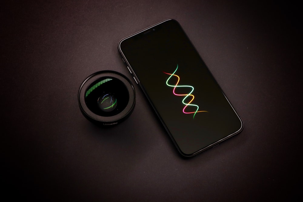 black smartphone and black zoom lens