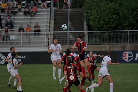 Adults enjoying a friendly coed soccer match with vibrant community energy.