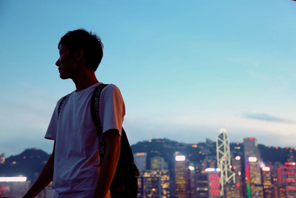 man near high rise buildings