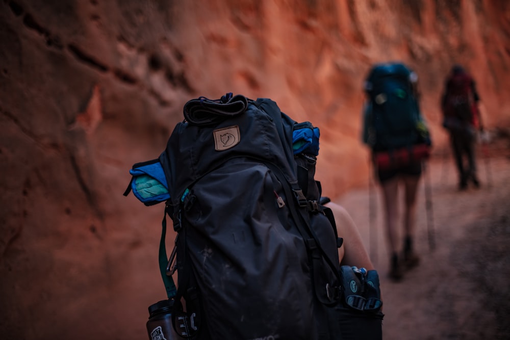 unknown person carrying black backpack