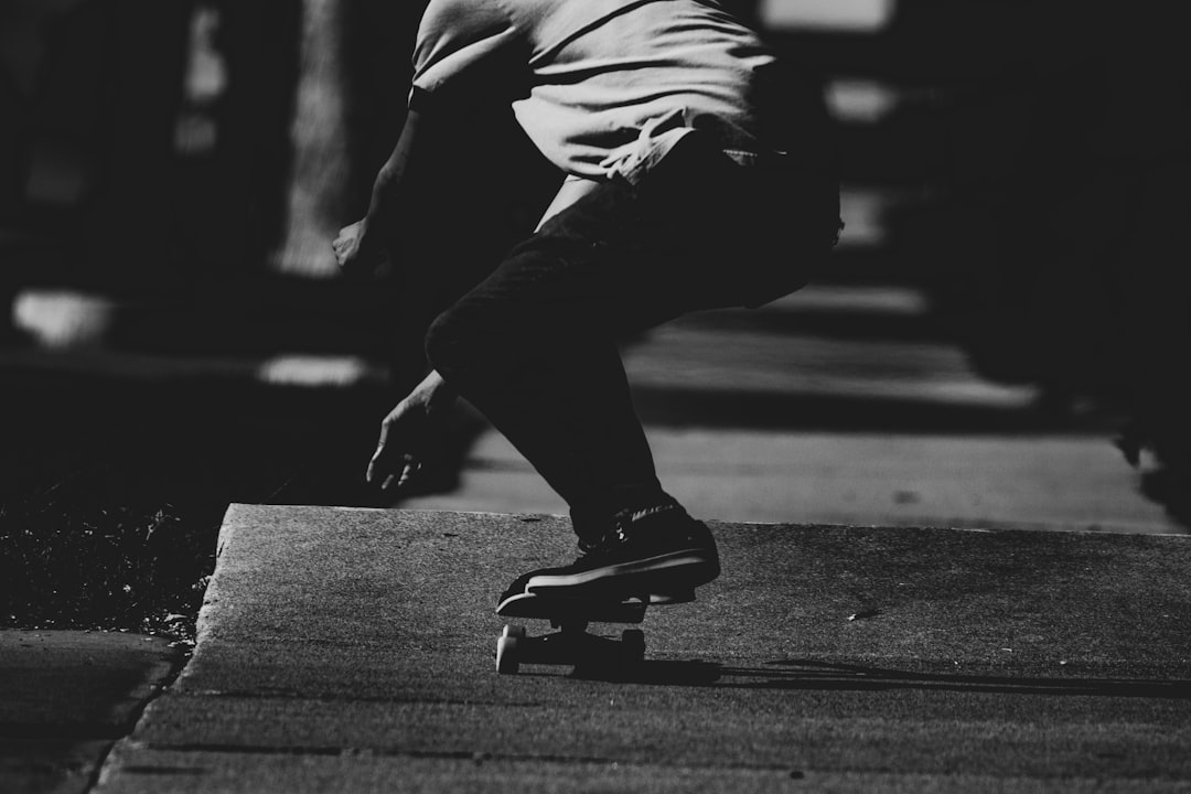 grayscale photography of person skatng