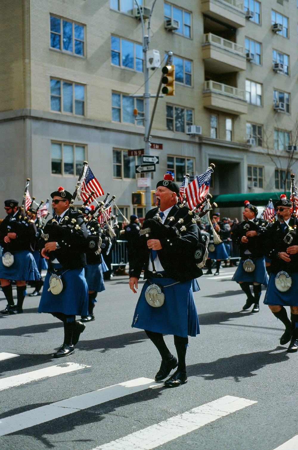 group of men playing bag pipes at the road