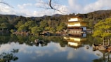 Evening view of Kinkaku-ji reflecting on the tranquil pond under a soft sky.