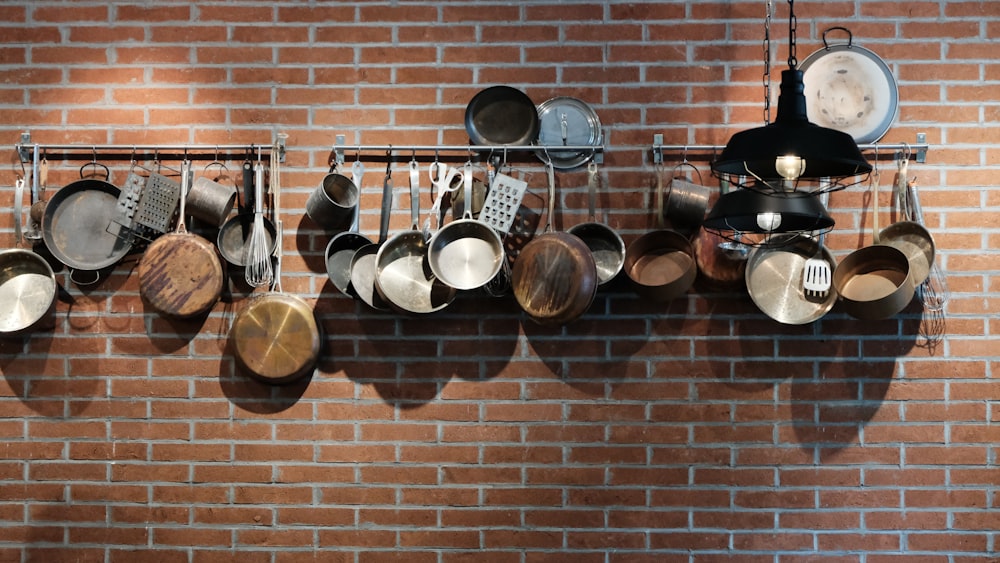 assorted cooking pan on wall rack