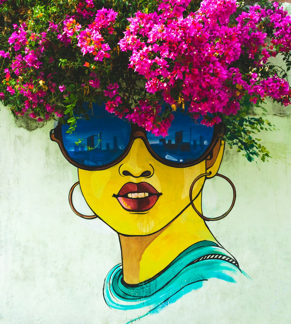 woman wearing sunglasses wall painting near pink bougainvillea flowers