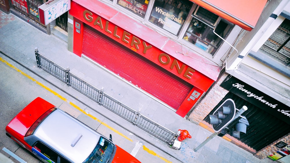 red car on road near Gallery One building