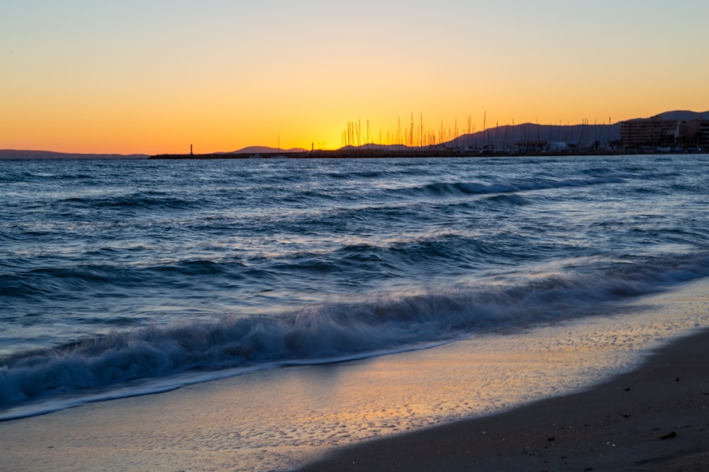 blue sea waves during sunrise