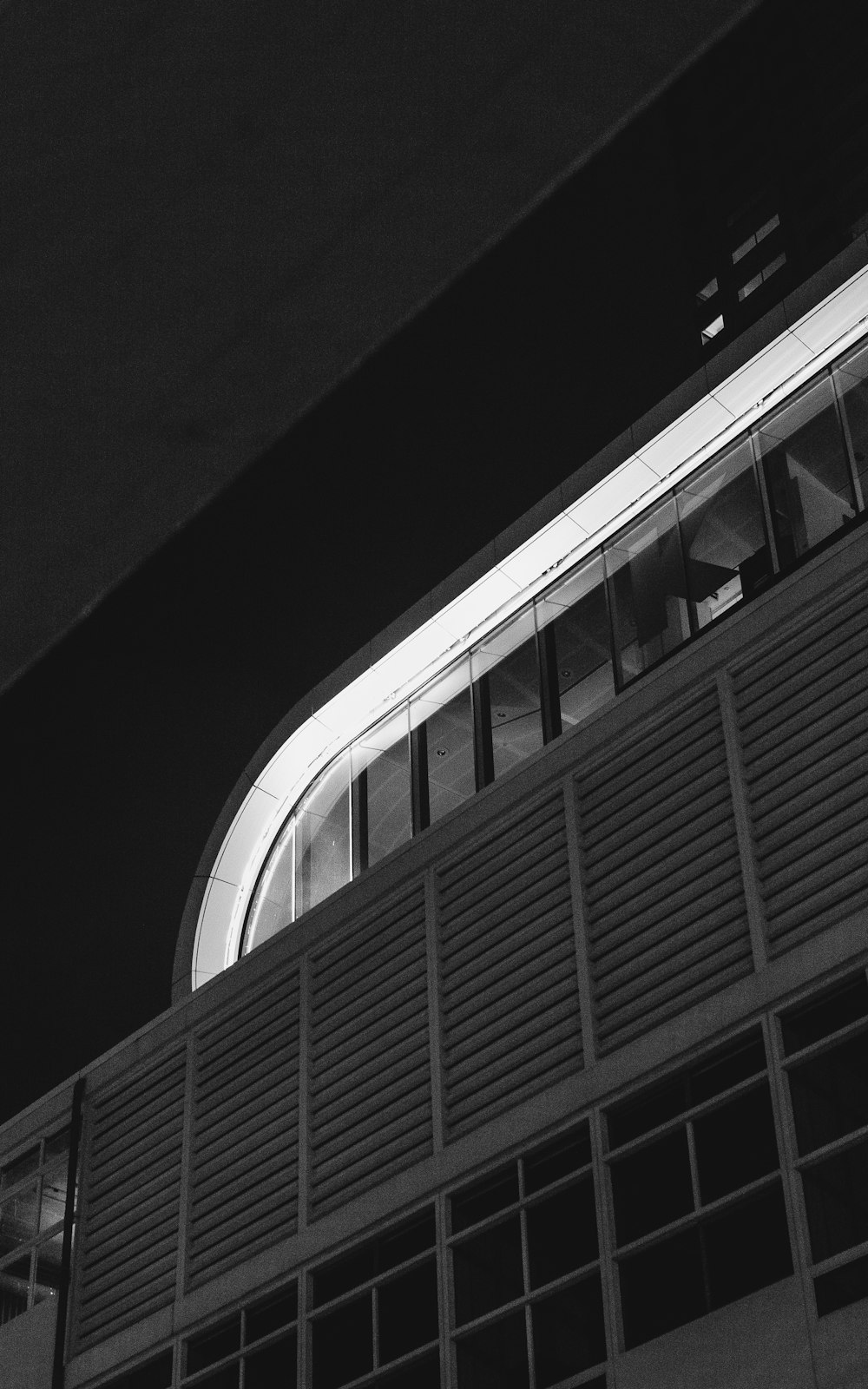 a black and white photo of a building at night