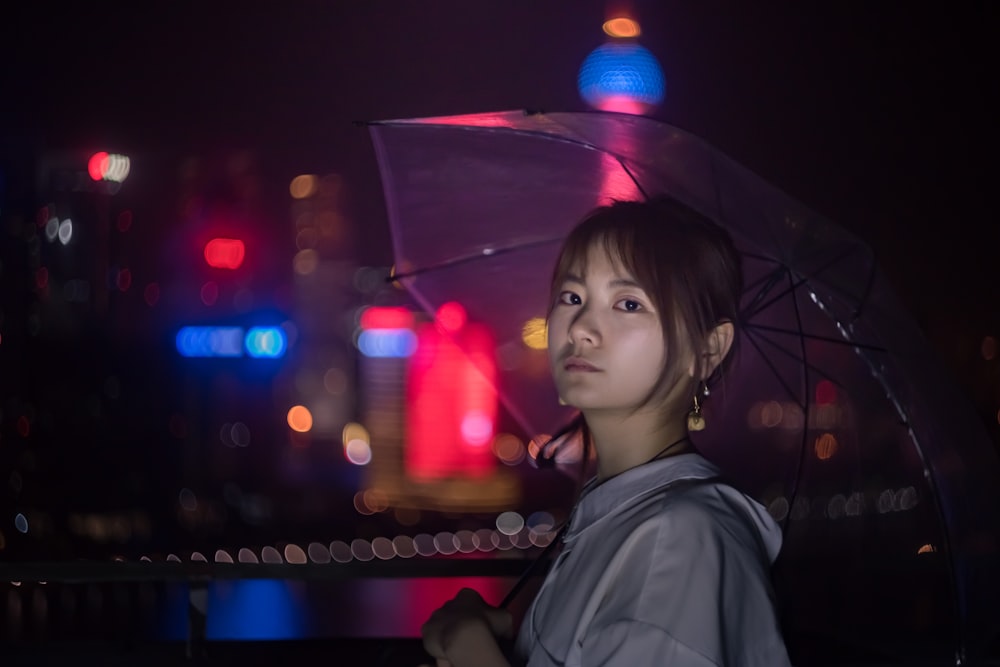 bokeh photography unknown person carrying clear umbrella