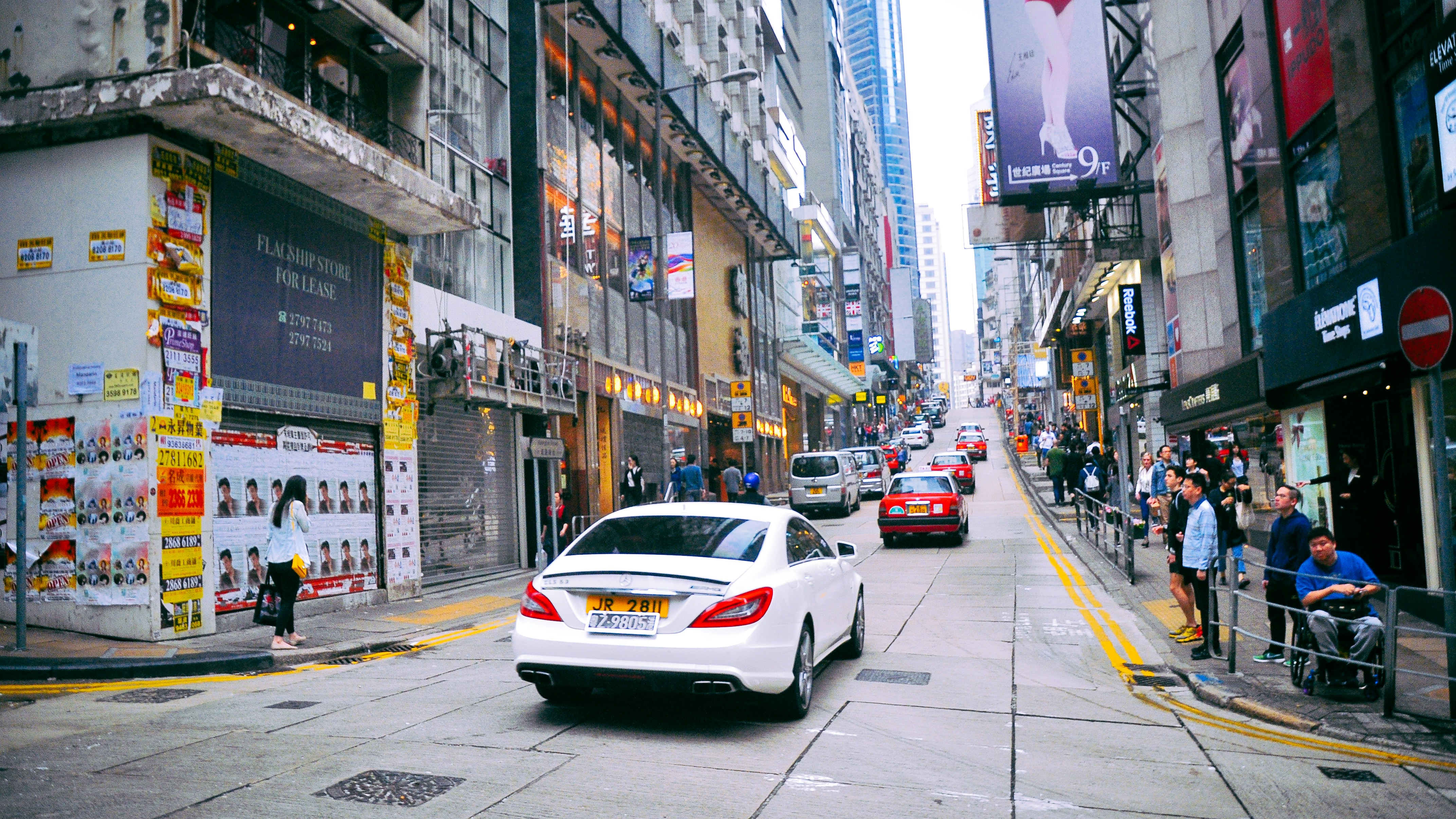 Blue Toyota RAV4 Hybrid driving in a city street with traffic